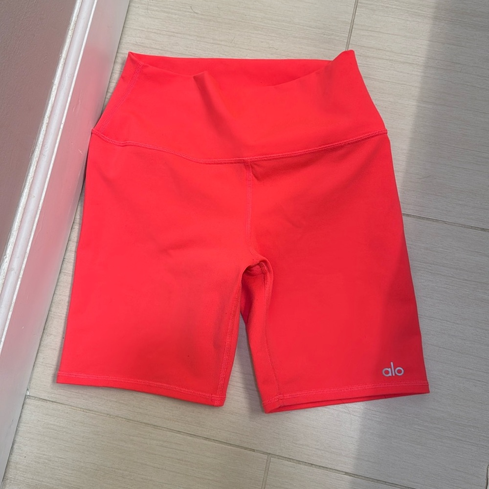 Alo Yoga High Waist Biker Shorts. Color is PINK LAVA.